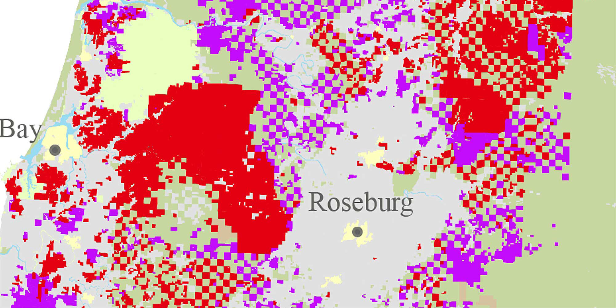 A colorful ownership map of southwestern Oregon near Roseburg, showing a patchwork of red, purple, yellow, and green areas indicating different land management boundaries.